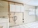 Laundry room with white cabinets and shelving at 1210 Lady Elaine Dr, Valrico, FL 33594