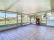 Spacious screened porch with tiled flooring, offering a peaceful outdoor space at 1210 Lady Elaine Dr, Valrico, FL 33594