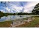 Serene waterfront view with benches, ideal for relaxation at 209 N Saint Thomas Cir, Apollo Beach, FL 33572