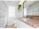 Bright bathroom boasts granite counters, white cabinets, and a shower/tub combination at 23635 Oakside Blvd, Lutz, FL 33559