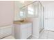 Bathroom featuring a modern vanity, mirror, and a glass-enclosed shower at 23635 Oakside Blvd, Lutz, FL 33559