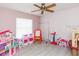 bedroom featuring laminate flooring, a ceiling fan, and ample storage space at 23635 Oakside Blvd, Lutz, FL 33559