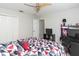 Bedroom offers a ceiling fan, double closets, and a view of the home's workspace at 23635 Oakside Blvd, Lutz, FL 33559