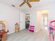 Bright bedroom with wood-look floors and natural light from an open doorway at 23635 Oakside Blvd, Lutz, FL 33559