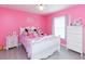 Pink bedroom offers a charming white bed and matching dressers at 23635 Oakside Blvd, Lutz, FL 33559