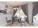 Dining area with chandelier lighting and sliding glass doors to the lanai and pool at 23635 Oakside Blvd, Lutz, FL 33559