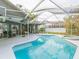 Screened-in pool and patio area with ample seating, perfect for entertaining at 23635 Oakside Blvd, Lutz, FL 33559
