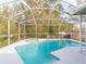 Sparkling screened-in pool and spa, perfect for relaxation and enjoyment at 23635 Oakside Blvd, Lutz, FL 33559