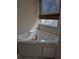 Bathroom with corner jacuzzi tub and window at 2365 Ardenwood Dr, Spring Hill, FL 34609