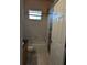 Simple bathroom with a tub and wood-like accent wall at 2365 Ardenwood Dr, Spring Hill, FL 34609