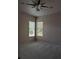Bedroom with ceiling fan and large windows at 2365 Ardenwood Dr, Spring Hill, FL 34609