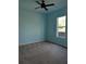 Bright bedroom with ceiling fan and large window at 2365 Ardenwood Dr, Spring Hill, FL 34609