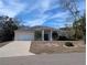 Tan one-story house with a garage and driveway at 2365 Ardenwood Dr, Spring Hill, FL 34609