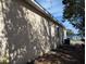 Side of house with window and tree shadows at 2365 Ardenwood Dr, Spring Hill, FL 34609
