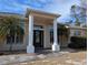 Home entrance with columns and stone flooring at 2365 Ardenwood Dr, Spring Hill, FL 34609