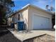 White double garage door and side yard view at 2365 Ardenwood Dr, Spring Hill, FL 34609