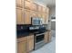 Kitchen features stainless steel appliances and dark countertops at 2365 Ardenwood Dr, Spring Hill, FL 34609