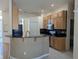 Kitchen with curved breakfast bar and granite countertop at 2365 Ardenwood Dr, Spring Hill, FL 34609