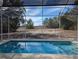 Relaxing screened-in pool overlooking backyard at 2365 Ardenwood Dr, Spring Hill, FL 34609