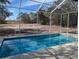 Relaxing screened-in pool with open backyard view at 2365 Ardenwood Dr, Spring Hill, FL 34609