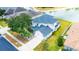Two-story house with a lake view, and a well-manicured lawn at 3533 Juneberry Drive, Wesley Chapel, FL 33543
