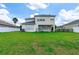 Large backyard with a grassy area and home's back elevation at 3533 Juneberry Drive, Wesley Chapel, FL 33543
