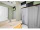 Clean bathroom with a single sink vanity, shower/tub combo, and gray shower curtain at 3533 Juneberry Drive, Wesley Chapel, FL 33543