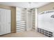 Bright bedroom with a large closet featuring shelves and drawers at 3533 Juneberry Drive, Wesley Chapel, FL 33543