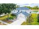 Two-story house with a lake view, and a well-manicured lawn at 3533 Juneberry Drive, Wesley Chapel, FL 33543