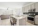 Modern kitchen with island, stainless steel appliances, and white cabinets at 3533 Juneberry Drive, Wesley Chapel, FL 33543