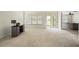Open living room with view to kitchen and access to backyard at 3533 Juneberry Drive, Wesley Chapel, FL 33543