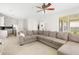 Open concept living room and kitchen with an L-shaped sofa at 3533 Juneberry Drive, Wesley Chapel, FL 33543
