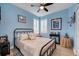 Guest bedroom with metal frame bed and light and airy decor at 417 Brandywine Falls Ct, Apollo Beach, FL 33572