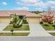 Attractive villa exterior, featuring a Spanish tile roof and two-car garage at 417 Brandywine Falls Ct, Apollo Beach, FL 33572