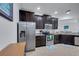 Modern kitchen with stainless steel appliances and ample dark wood cabinetry at 417 Brandywine Falls Ct, Apollo Beach, FL 33572