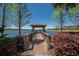 Wooden walkway leads to a peaceful gazebo over the lake at 417 Brandywine Falls Ct, Apollo Beach, FL 33572