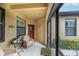 Cozy screened-in porch with wicker chairs and a small table at 417 Brandywine Falls Ct, Apollo Beach, FL 33572