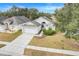 Aerial view showcasing a house with a driveway and surrounding landscape at 4605 Lisette Cir, Brooksville, FL 34604