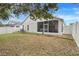 Large backyard with screened patio and white fence at 4605 Lisette Cir, Brooksville, FL 34604
