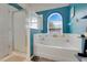 Bathroom features a soaking tub, shower, and an arched window with natural light at 4605 Lisette Cir, Brooksville, FL 34604