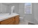 Clean bathroom with wood vanity, toilet and bathtub at 4605 Lisette Cir, Brooksville, FL 34604