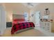 Main bedroom with plush bed, en-suite bathroom access, and vanity area at 4605 Lisette Cir, Brooksville, FL 34604