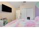 Bedroom with large TV, closet and colorful bedding at 4605 Lisette Cir, Brooksville, FL 34604