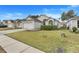 Front yard view of a house with a two-car garage and landscaping at 4605 Lisette Cir, Brooksville, FL 34604