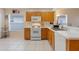 Spacious kitchen with light wood cabinets, ample counter space, and stainless steel appliances at 4605 Lisette Cir, Brooksville, FL 34604