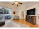 Living room with hardwood floors, sliding glass doors, and a fireplace at 4605 Lisette Cir, Brooksville, FL 34604