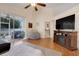 Living room with hardwood floors, sliding glass doors, and a fireplace at 4605 Lisette Cir, Brooksville, FL 34604