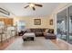 Living room with a sectional sofa, hardwood floors, and access to the kitchen at 4605 Lisette Cir, Brooksville, FL 34604