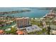 Aerial view of waterfront condo building with pool, parking, and tennis court at 4900 Brittany S Dr # 701, St Petersburg, FL 33715