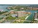 Aerial view of waterfront community, featuring a high-rise building, pool, and tennis courts at 4900 Brittany S Dr # 701, St Petersburg, FL 33715